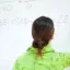 Photo of Student Doing Math Problems at a Whiteboard